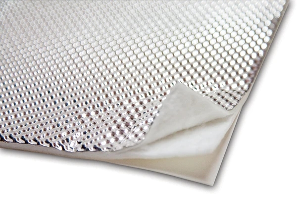 Peel and stick heat shield installed on automotive firewall